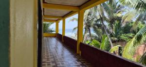 a hallway leading to a balcony with a view of the ocean at Aabhai Beach Resort, Malvan in Malvan +32 photos