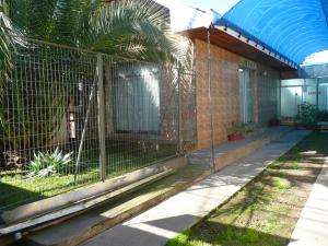 einen Zaun an der Seite eines Gebäudes in der Unterkunft Hospedaje Glamour in Machalí