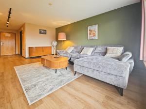 a living room with a couch and a coffee table at Hotel Aeschi Interlaken - Handwritten Collection in Aeschi