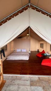 a bedroom with a bed in a tent at Royal Mulia by MaPan atroomS in Cigugur