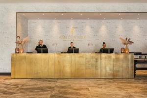 a group of people sitting at a reception desk at Van der Valk Hotel Amsterdam - Amstel in Amsterdam