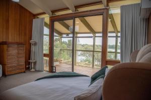 a bedroom with a bed and a large window at Willow Lodge Retreat in Paringa +94 photos