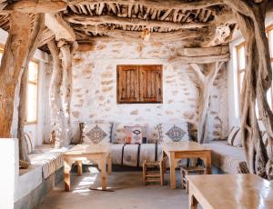 a room with a couch and tables and trees at Wilde Tigmi in Essaouira