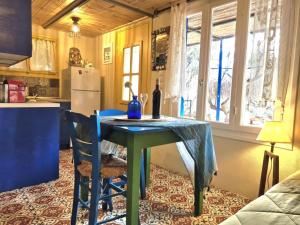 a kitchen with a table with a bottle of wine on it at SOULIS GUESTHOUSE in Megáli Mandínia +26 photos