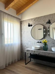 a bathroom with two sinks and a mirror at Tenuta Tommasi - Relais Bacco in Caorle