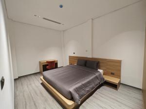 a bedroom with a large bed in a room at Minerva Aparthotel Hanoi in Hanoi