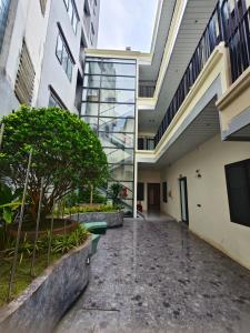 an empty hallway in a school building with trees at Minerva Aparthotel Hanoi in Hanoi