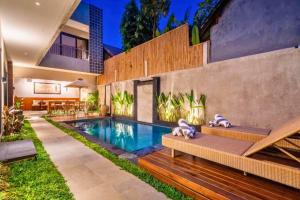 a swimming pool in the backyard of a house at Esmeralda1 BR Shared Pool ZN284 in Pererenan