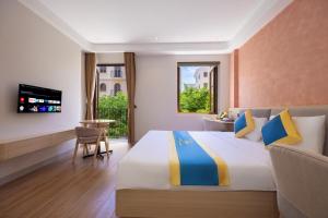 a bedroom with a large bed and a television at Anh Thắng Hotel in Phu Quoc