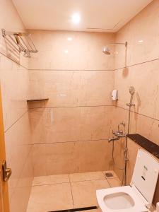 a bathroom with a toilet and a shower at tan90 Comfort Stays in Tiruchchirāppalli