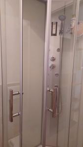 a shower in a bathroom with a glass door at A-Mare in Viareggio