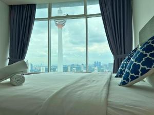 a bedroom with a bed with a view of the space needle at Vortex Apartments Kuala Lumpur in Kuala Lumpur
