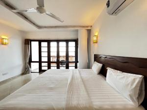 a bedroom with a large bed in a room at Shabiki Sea View Apartments in Mombasa
