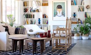 a living room with a table and chairs and a couch at Desert Muse - Midcentury Retreat w Pool Views in Joshua Tree