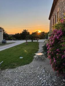 a bench sitting on a gravel path next to a building at Maison du Berger - Vignoble Château Barbebelle, Rognes, maison provençale avec jardin partagé et parking - proche d'Aix-en-Provence - 5 personnes in Rognes