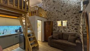a living room with a loft bed and a kitchen at Sadarmis Houses in Leonidio