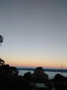 a view of the ocean at sunset at เอวาเฮ้าส์ ภูชี้ฟ้า avahouse phuchifa in Ban Seng Choi