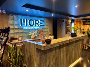 a coffee shop with a sign on the front of it at MORE Patong Hotel in Patong Beach