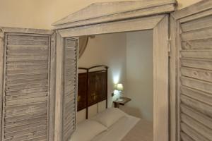 a bedroom with a canopy bed with a mirror at Torre della Botonta in Castel Ritaldi +96 photos