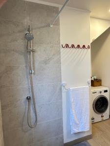 a shower with a shower head in a bathroom at Camellia Romance Retreat near Doncaster Westfield M3 in Doncaster