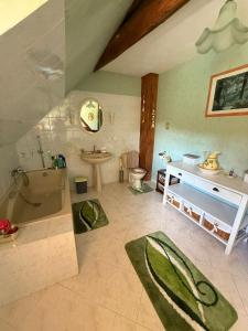 a bathroom with a tub and a sink and a toilet at Chez les Loulous in Chailly-sur-Armançon +16 photos