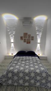 a bedroom with a large bed with lights on it at Mediterranean house in Djerba Midoun in Taguermess +46 photos