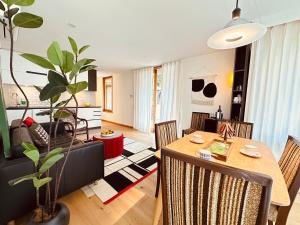 a living room with a table and a dining room at Forest Romance Retreat near Doncaster Westfield M3 in Doncaster