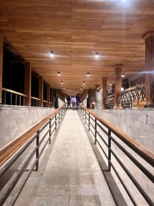 a long walkway in a building with a wooden ceiling at Explore bharat in Kedārnāth