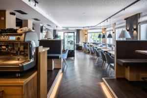 a restaurant with chairs and tables and a bar at Kiener by Blümel - Attergau in Sankt Georgen im Attergau
