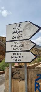 a street sign with arrows in a foreign language at GITE Vallee Verte in Inrarane +16 photos