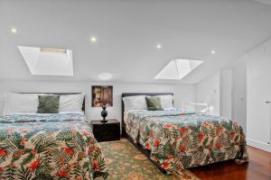 two beds in a room with white walls at Lisbon Rentals Chiado in Lisbon
