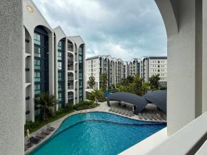 a view of a swimming pool with buildings at Modern 1 & 2 Bedroom Apartments Naiyang Phuket by Mango Family in Nai Yang Beach +3 photos
