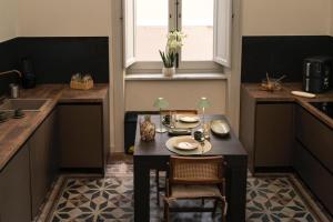 a small kitchen with a table and chairs in it at Silvia Home Suite in Palermo +58 photos
