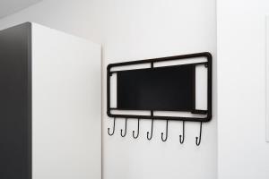 a mirror is hanging on a wall with nails at Modern roof terrace apartment fully equipped in Königsbrunn