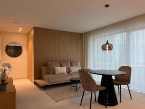 a living room with a couch and a table at Toploft Serviced Apartments in Crailsheim