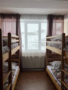 a room with three bunk beds and a window at 2-room Apartment NFT Gudauri Penta 404 in Gudauri