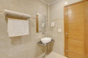 a bathroom with a toilet and a shower at Freesia 3-BHK Apartment With Common Gaming Zone Near Popular Malls in Noida