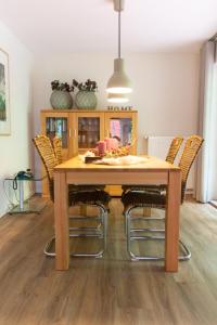 a dining room with a wooden table and chairs at Knipper RE24 in Sögel