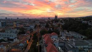 a view of a city at sunset at Flex SelfCheckIns 130 - Zagreb - Studio Apartment - Center in Zagreb