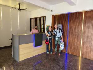 a group of people standing in front of a counter at The Opal Hotel in Greater Noida