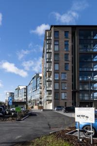 a parking lot in front of a large building at Sarvvik Golf and Lakeside Apartment in Sarvvik +8 photos