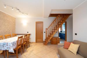 a kitchen and dining room with a table and a staircase at Chalet Edera Myholidaylivigno in Livigno