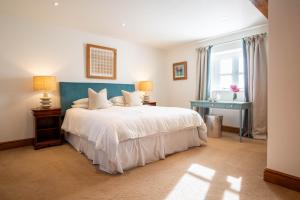 Postel nebo postele na pokoji v ubytování Stockmans Cottage