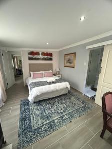 a bedroom with two beds and a rug at 13 on Newington in Gqeberha +15 photos