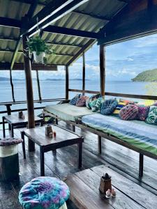 a room with two beds and a view of the ocean at On the Rocks in Koh Rong Sanloem