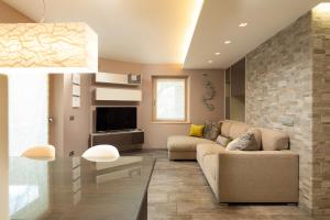 a living room with a couch and a tv at Chalet Edera Myholidaylivigno in Livigno