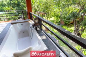 a bath tub sitting on top of a balcony at THE ONE VILLA in Chiang Mai