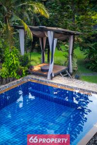 a gazebo next to a swimming pool at THE ONE VILLA in Chiang Mai