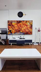 a white bench in a room with a tv on a wall at 부산해운대바다품 in Busan