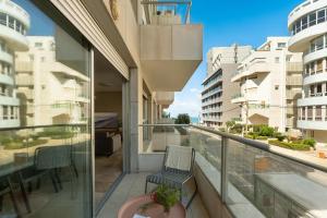 a balcony with a view of a building at Gordon Beach Bright Spacious Stay in Tel Aviv